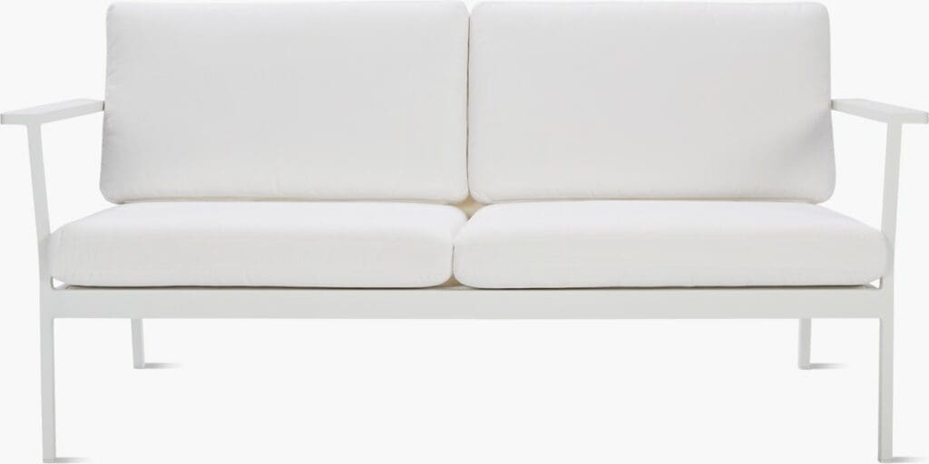A modern white sofa with plush cushions and a minimalist metal frame.