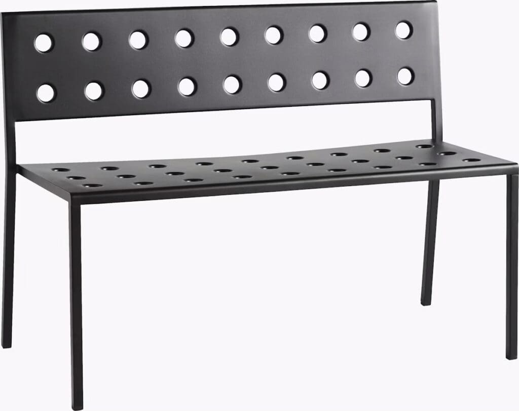 A modern black bench with a perforated design featuring circular holes along the backrest and seat.