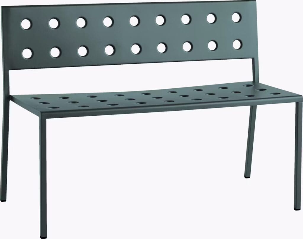 A modern bench with a perforated design, featuring circular holes in the backrest and seat, made from metal with sleek lines.