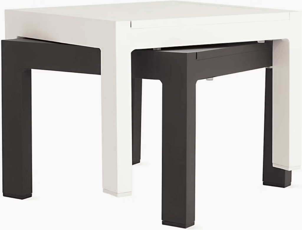 Modern nesting side tables in black and white colors, featuring a sleek design with a minimalist aesthetic.