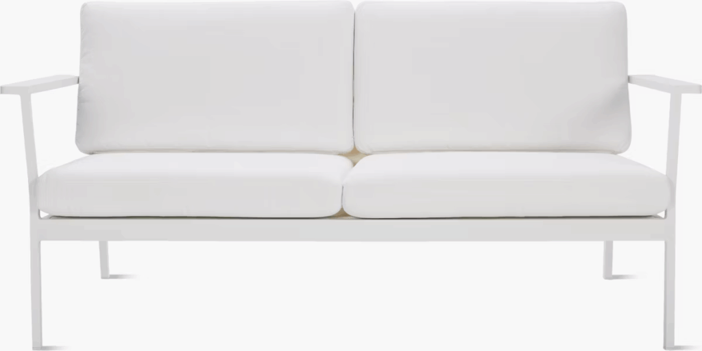 Modern outdoor loveseat with white cushions and a sleek white frame.