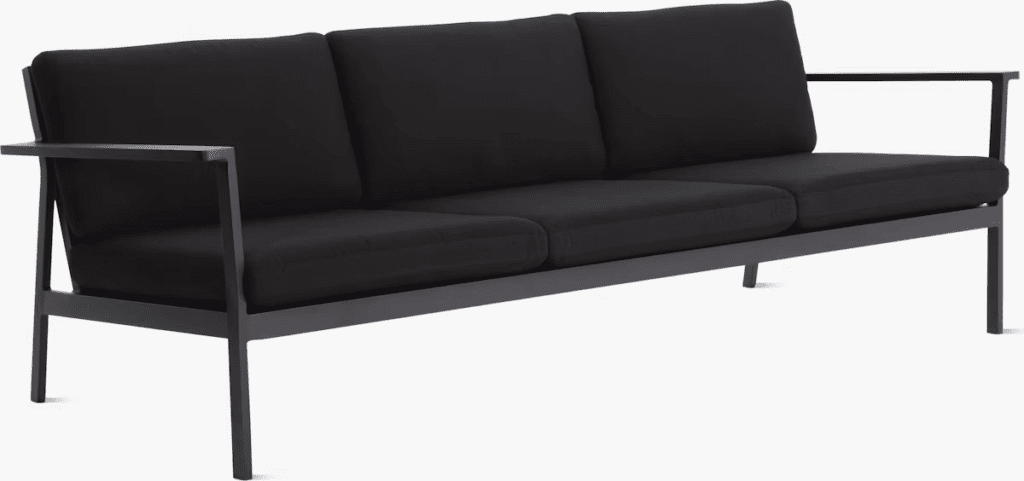 Modern black outdoor sofa with three cushions and metal frame, designed for luxury spaces.