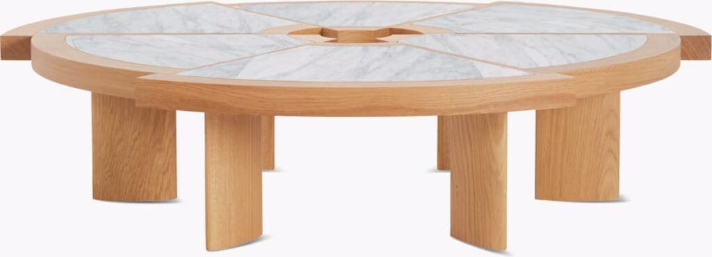 A low coffee table featuring a unique design with six offset radial segments and a solid oak base, topped with Carrara marble.