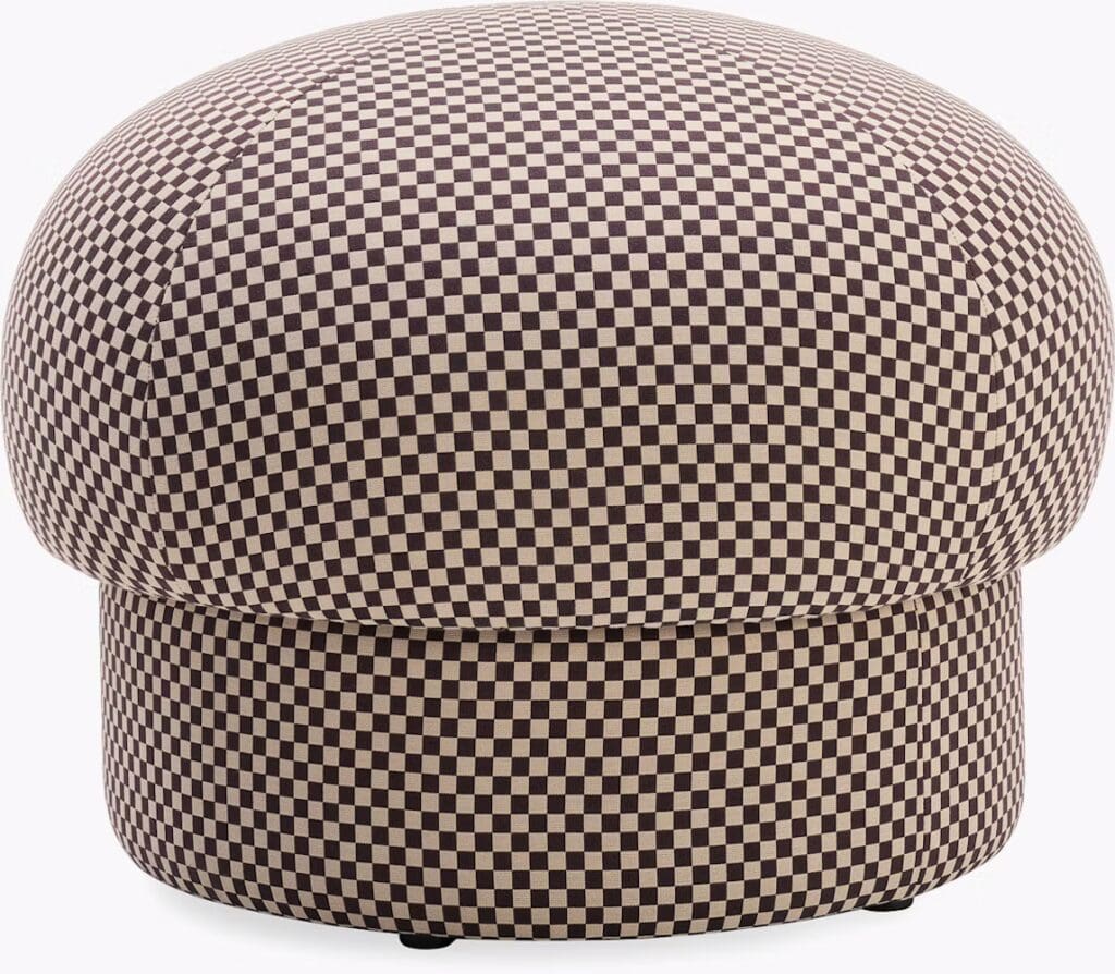 A round ottoman upholstered in a checkered pattern of dark brown and beige, showcasing a modern design.