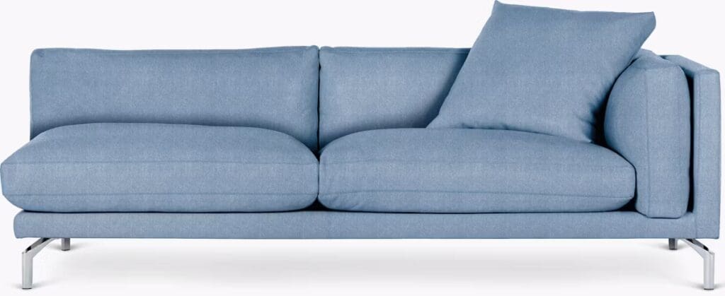 A modern light blue sofa with clean lines and a single decorative cushion, featuring a minimalist design and metal legs.