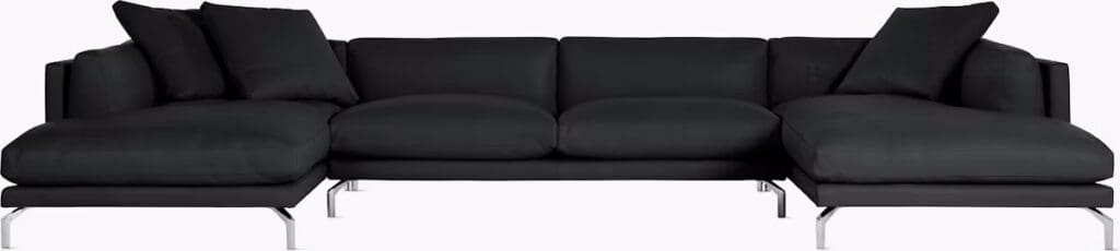 Modern black sectional sofa with cushions, featuring a sleek design and metal legs.