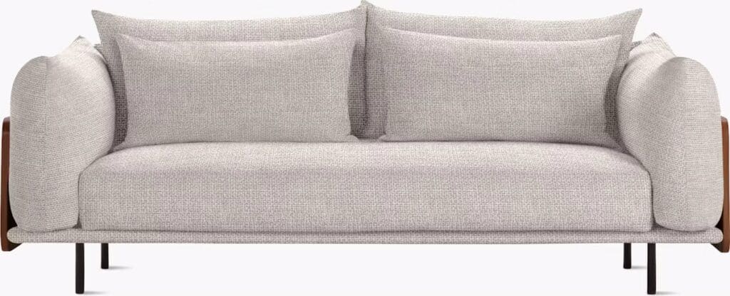 A stylish, modern sofa with plush cushions and a minimalist design, featuring rounded armrests and a sleek base.