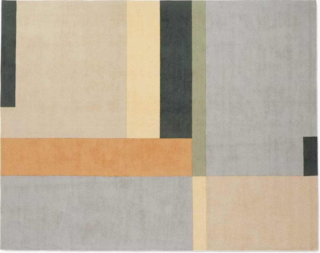 A modern area rug featuring an abstract geometric design with various colors including beige, gray, orange, and green.
