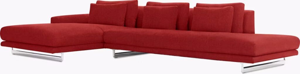 Modern red sectional sofa with plush cushions and chrome legs.