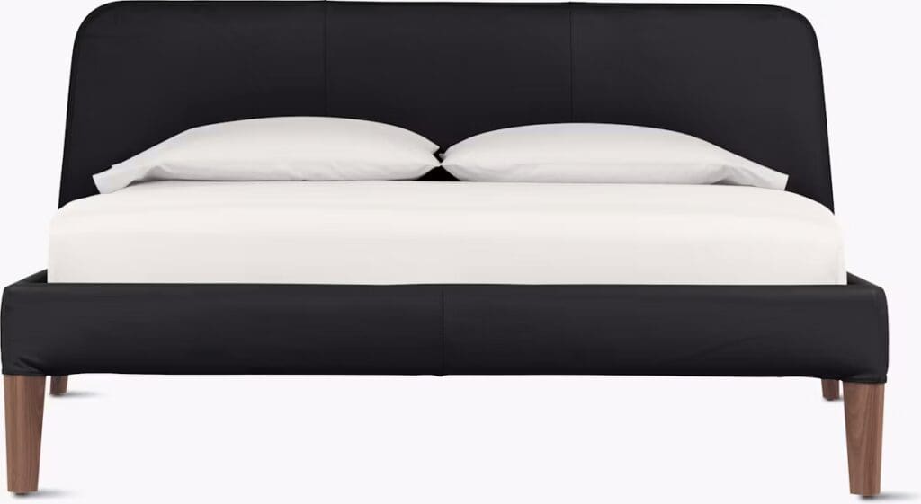 Modern black bed frame with a padded headboard and wooden legs, featuring a minimalist design.