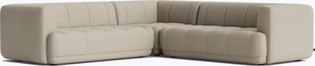 A modern beige sectional sofa with a tufted design, featuring clean lines and a minimalist aesthetic, suitable for a contemporary living room.