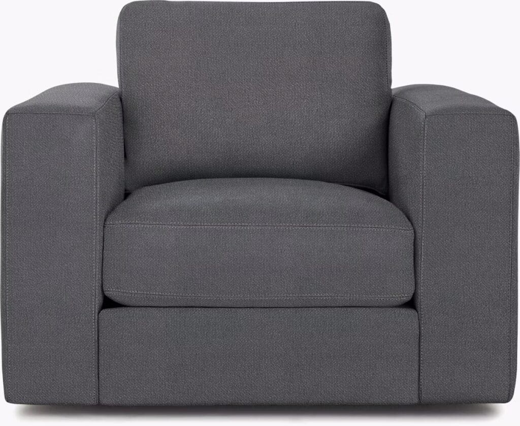A modern gray armchair featuring a boxy design with firm cushions and clean lines.