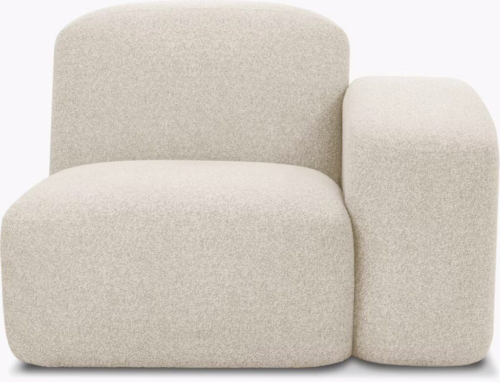 A contemporary cream-colored chair with soft, rounded edges and plush upholstery, designed for modern living spaces.