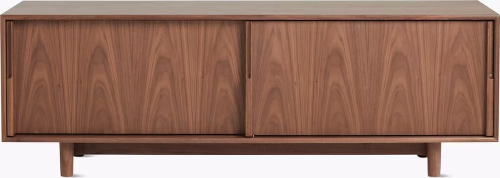 A wooden sideboard with two sliding doors and tapered legs, showcasing a rich walnut finish.