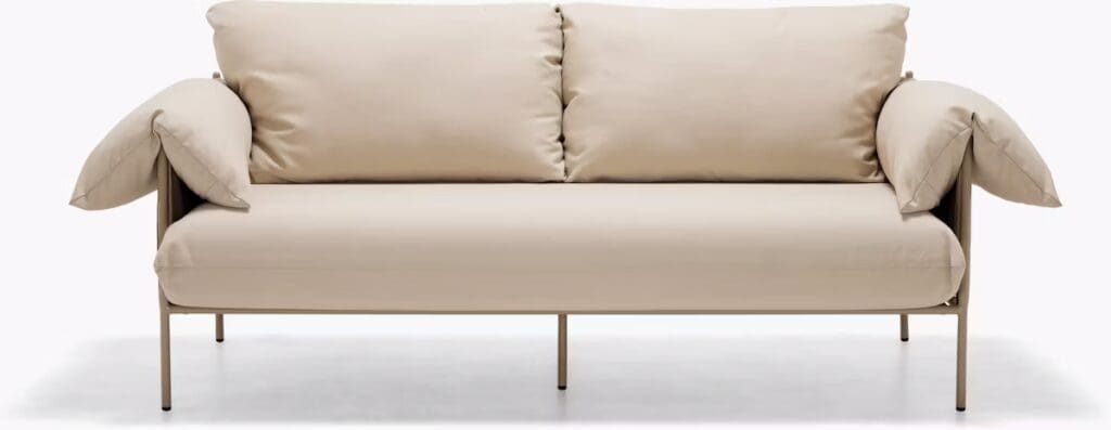 A modern beige sofa with plush cushions and a minimalist metal frame, showcasing a stylish and contemporary design.