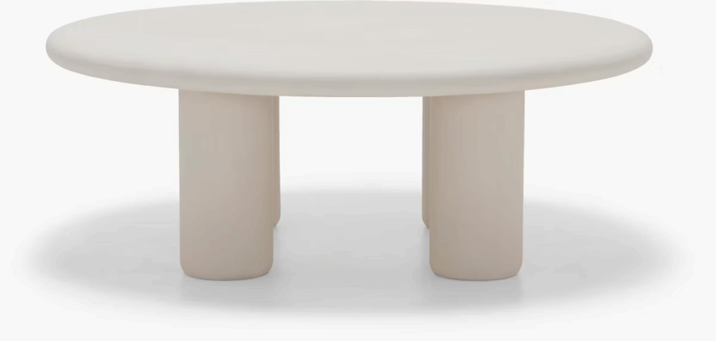 Modern round coffee table with a smooth top and cylindrical legs, showcasing a minimalist design.