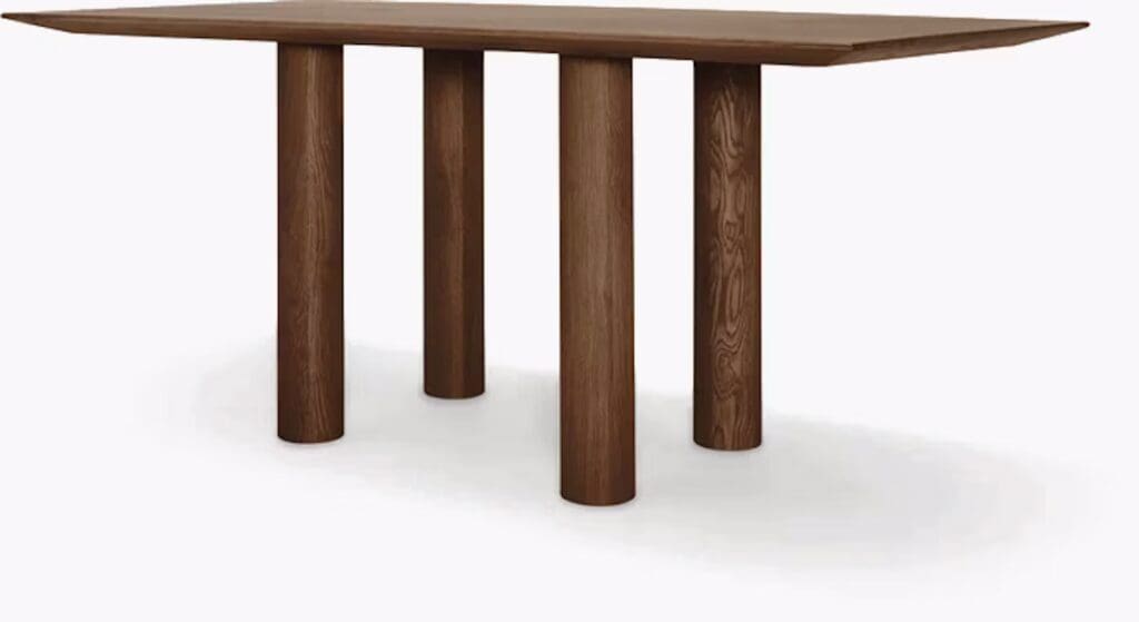 A modern wooden dining table with a unique design featuring a rectangular top and three cylindrical legs.