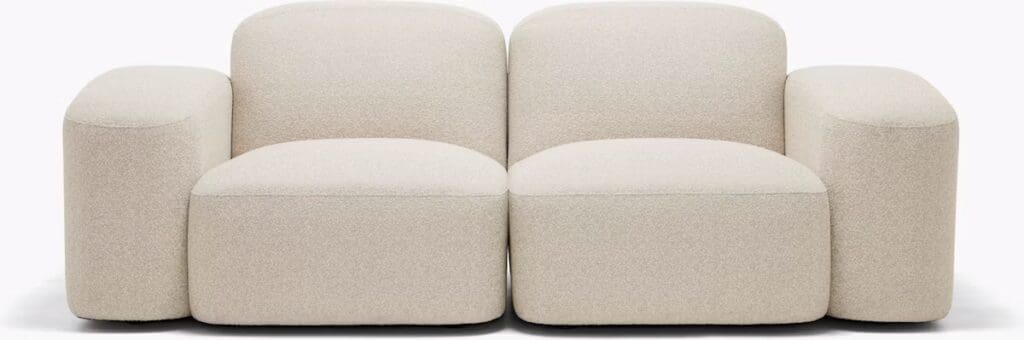 A modern, plush sofa with rounded edges and a beige textile finish, showcasing a contemporary design.
