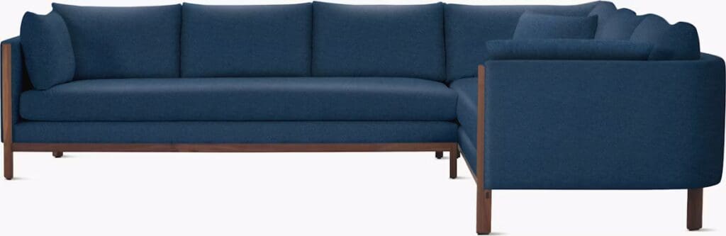 A modern, blue sectional sofa with a sleek wooden frame and plush cushions, designed for comfort and style.
