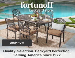 Luxurious outdoor living space with modern furniture, featuring a pool, surrounded by tropical plants and a clear blue sky.