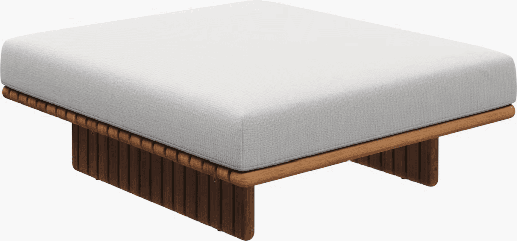 Modern outdoor coffee table with a minimalist design, featuring a white cushion atop a wooden base.