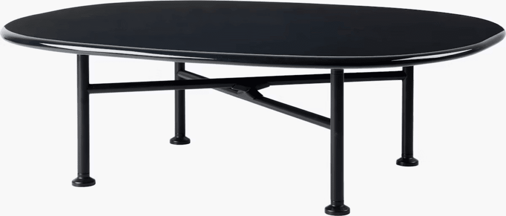 Modern black coffee table with a sleek oval top and minimalist black legs.
