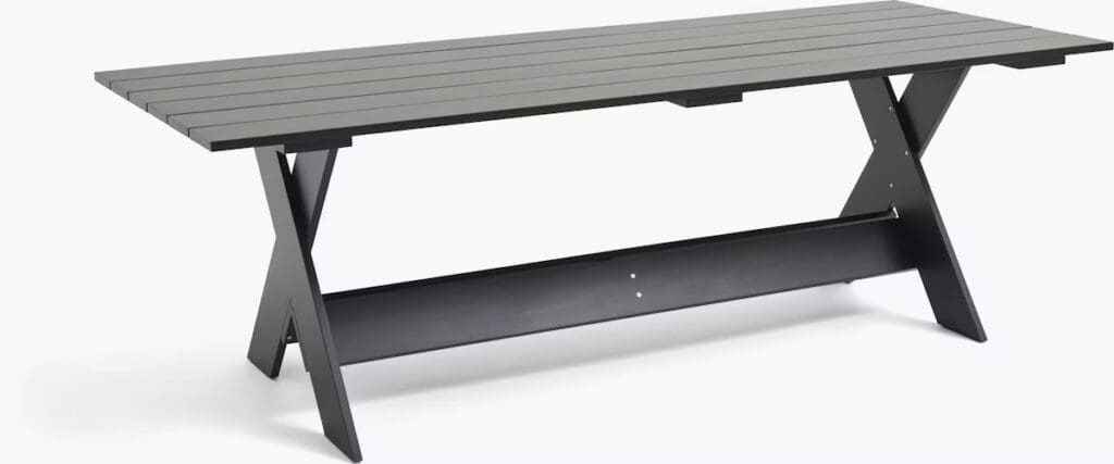 A modern outdoor dining table with a slatted top and a sturdy crossed-leg design, featuring a sleek black finish.