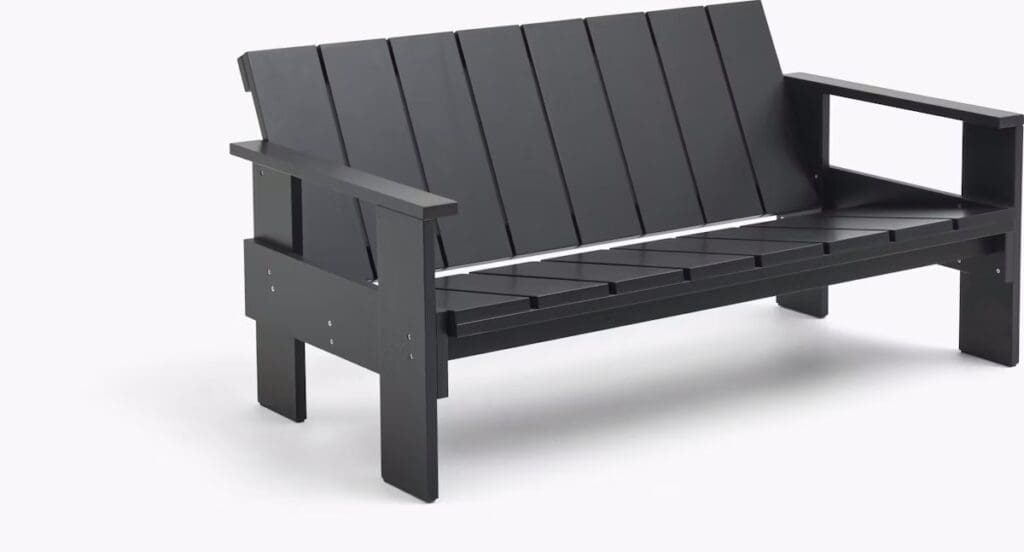 A modern Palissade Park Bench with slatted design, crafted for outdoor settings.