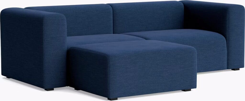 A modern blue fabric sofa with a minimalist design featuring rounded edges and a low profile.
