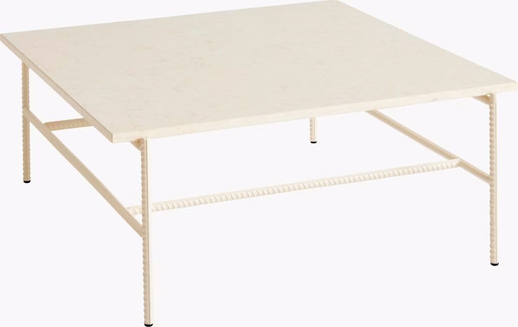 A minimalistic square coffee table with a white marble top and slender, textured metal legs.
