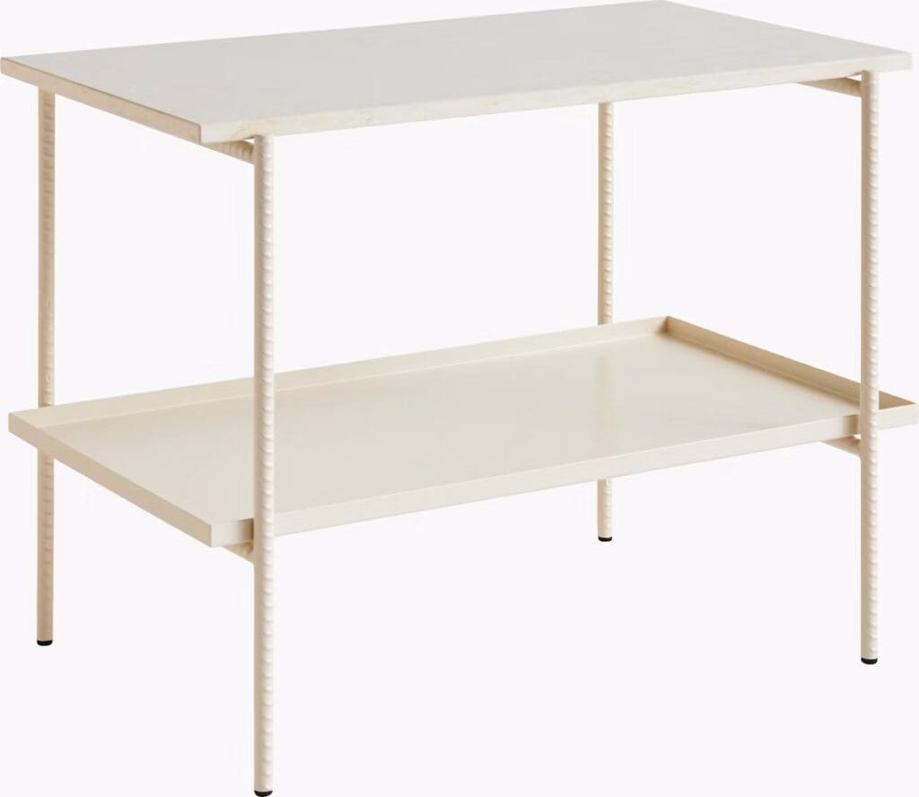 A sleek, modern side table with a rectangular top and a lower shelf, finished in a light color. Its legs feature a unique textured design.