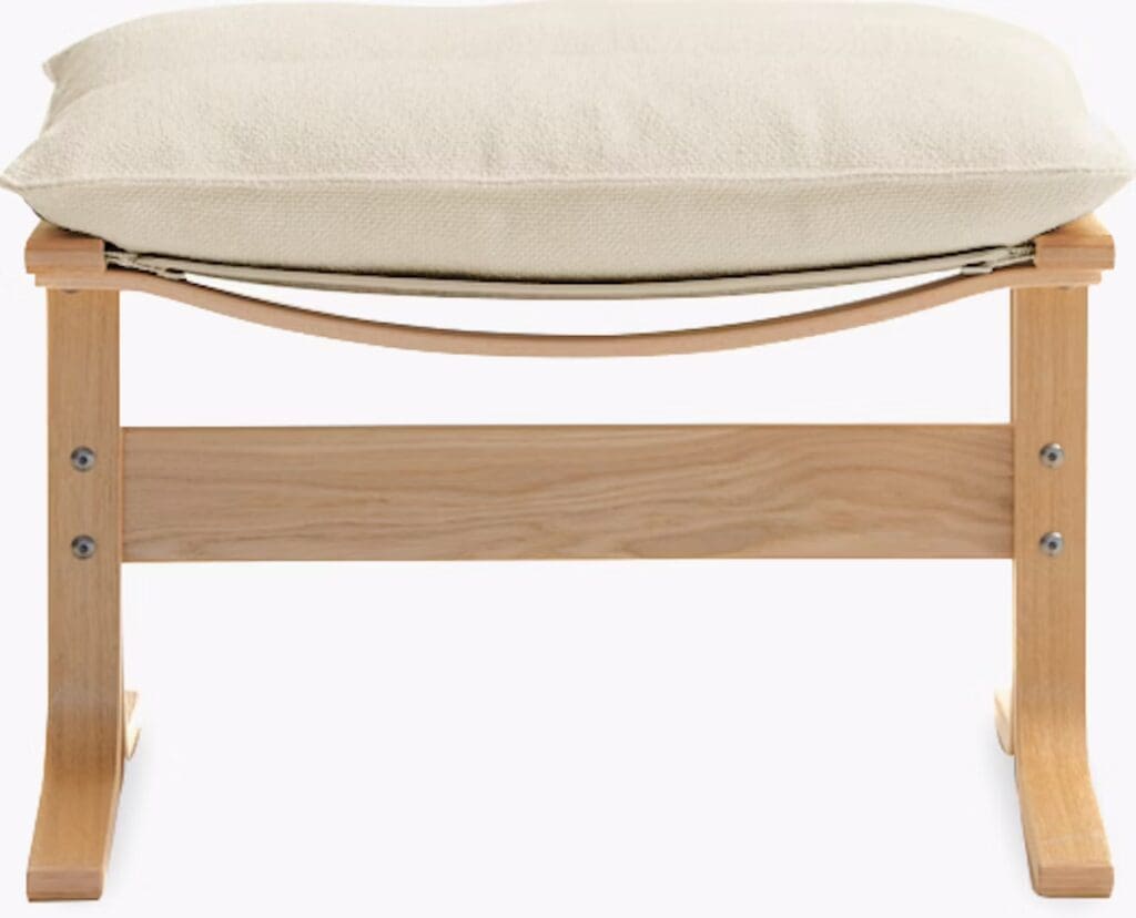 A wooden bench with a cream-colored cushion on top, showcasing a simple and modern design.