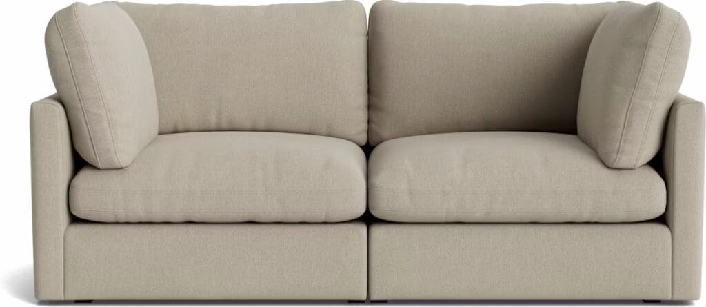 A modern and minimalist beige sectional sofa with plush cushions and large side pillows, designed for comfort and elegance.