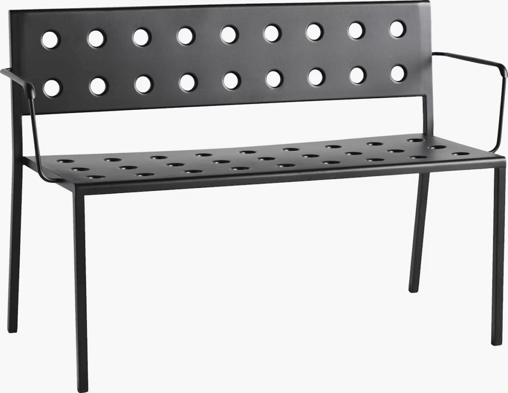 Modern black metal bench with circular cutouts in the backrest and seat.