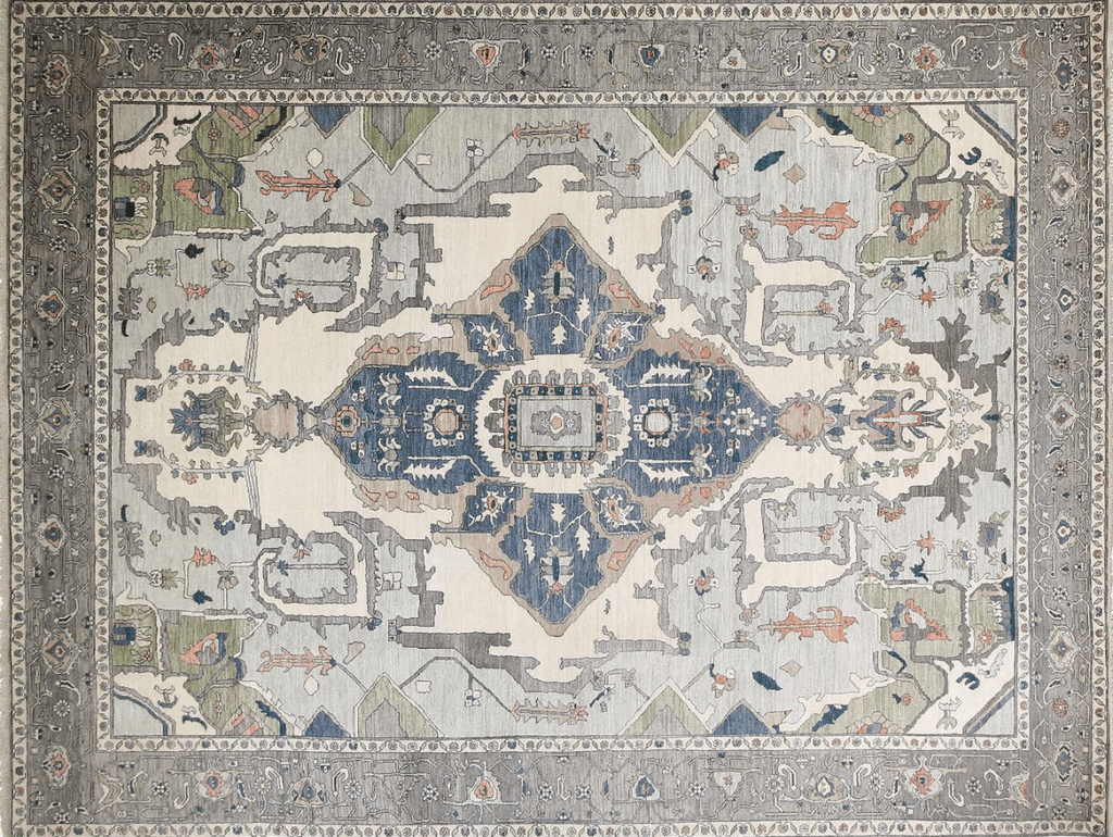 Vintage rug with intricate floral patterns in soft colors, featuring a central medallion and ornate border.