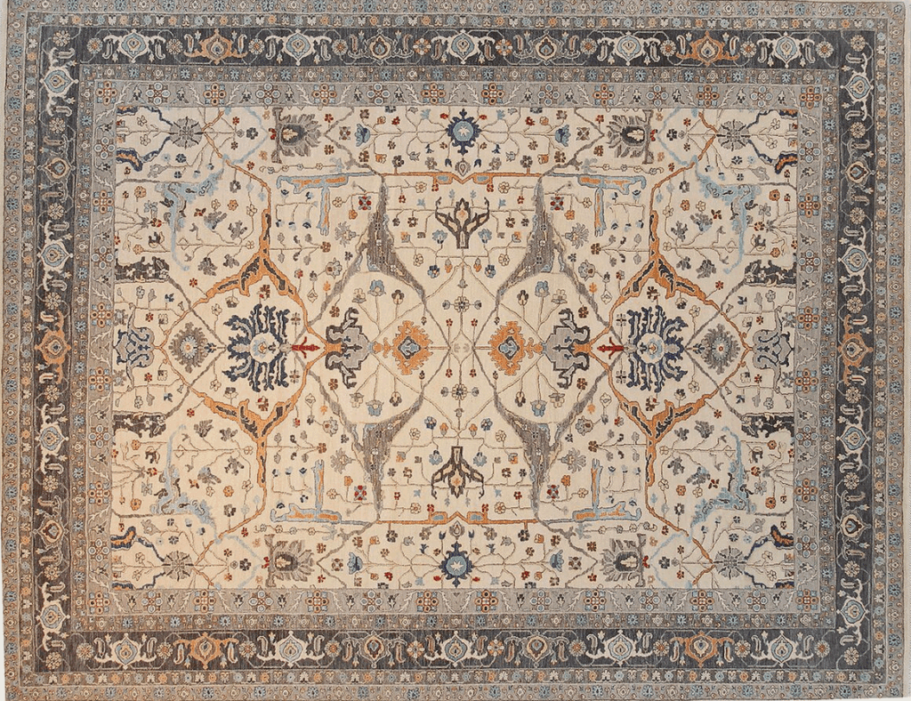 A vintage rug featuring intricate floral patterns in soft shades of beige, blue, and orange, with a central medallion and ornate border.