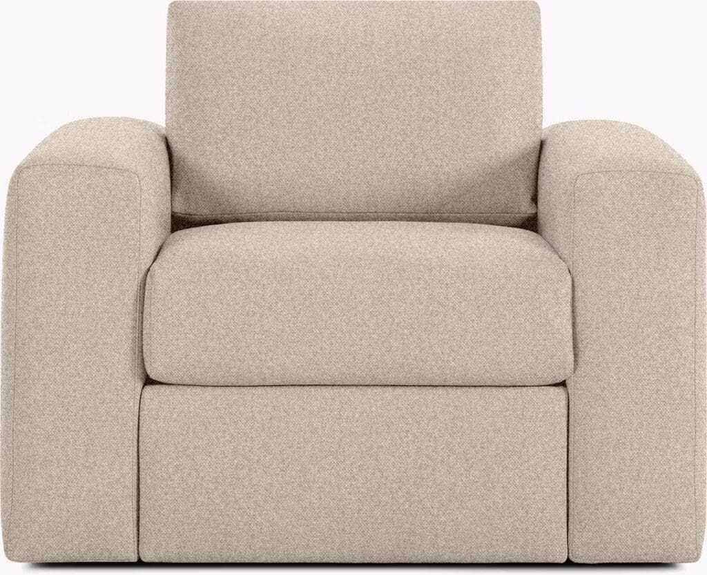 A modern, plush armchair in a light fabric design, featuring clean lines and a comfortable seat.