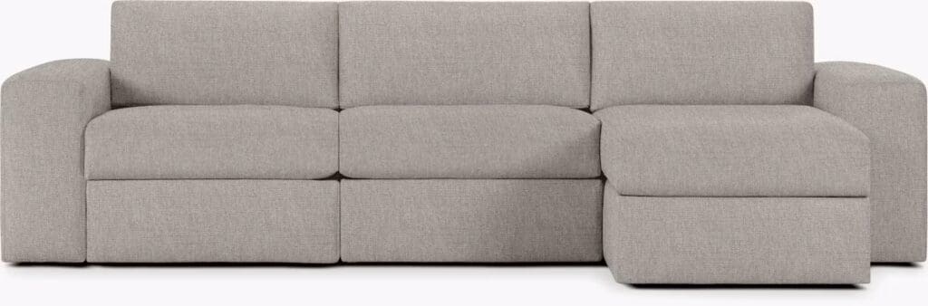 A modern grey sectional sofa with plush cushions and rounded arms, designed for comfort and relaxation.
