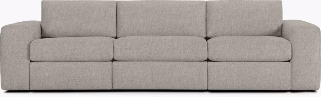 A modern, light gray sectional sofa with plush cushions and a minimalist design, featuring rounded edges and a low profile.