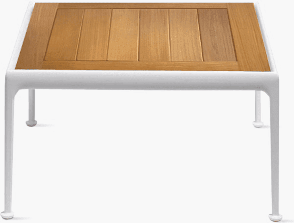 Modern outdoor coffee table with a white frame and wooden top, showcasing a sleek and minimalist design.