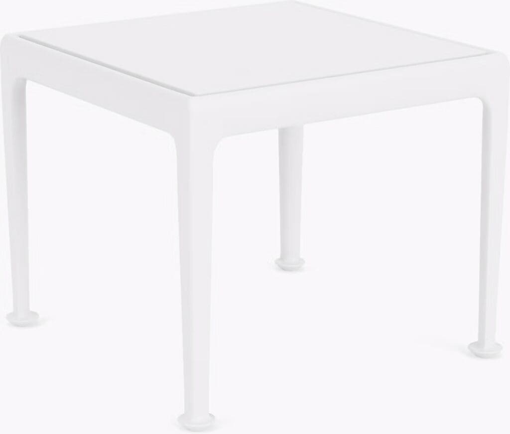 A modern white square table with four legs, featuring a clean and minimalist design, suitable for various decor styles.