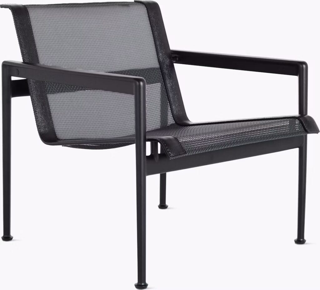A modern black armchair with a sleek, minimalist design featuring a mesh seat and backrest, supported by a sturdy metal frame.