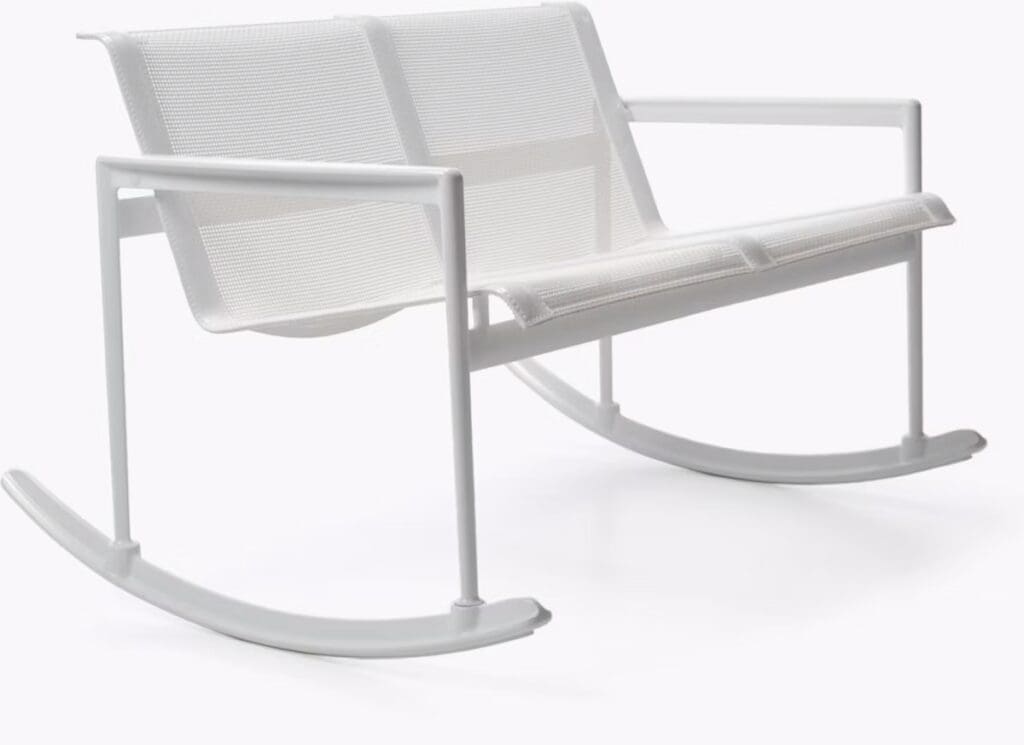 A modern white rocking chair with a minimalist design, featuring a mesh back and seat, set against a plain background.