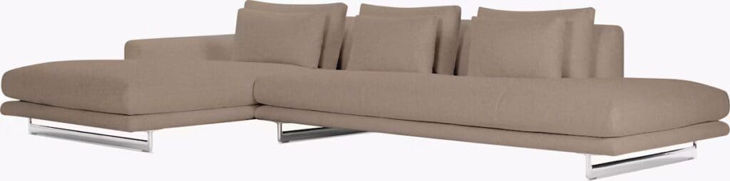 A modern beige sectional sofa with a minimalist design, featuring plush cushions and a chrome base.
