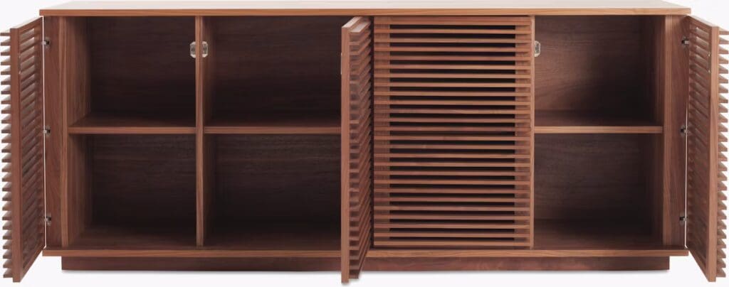 A modern walnut media cabinet with a flat top, featuring two sets of louvered doors and four spacious compartments.