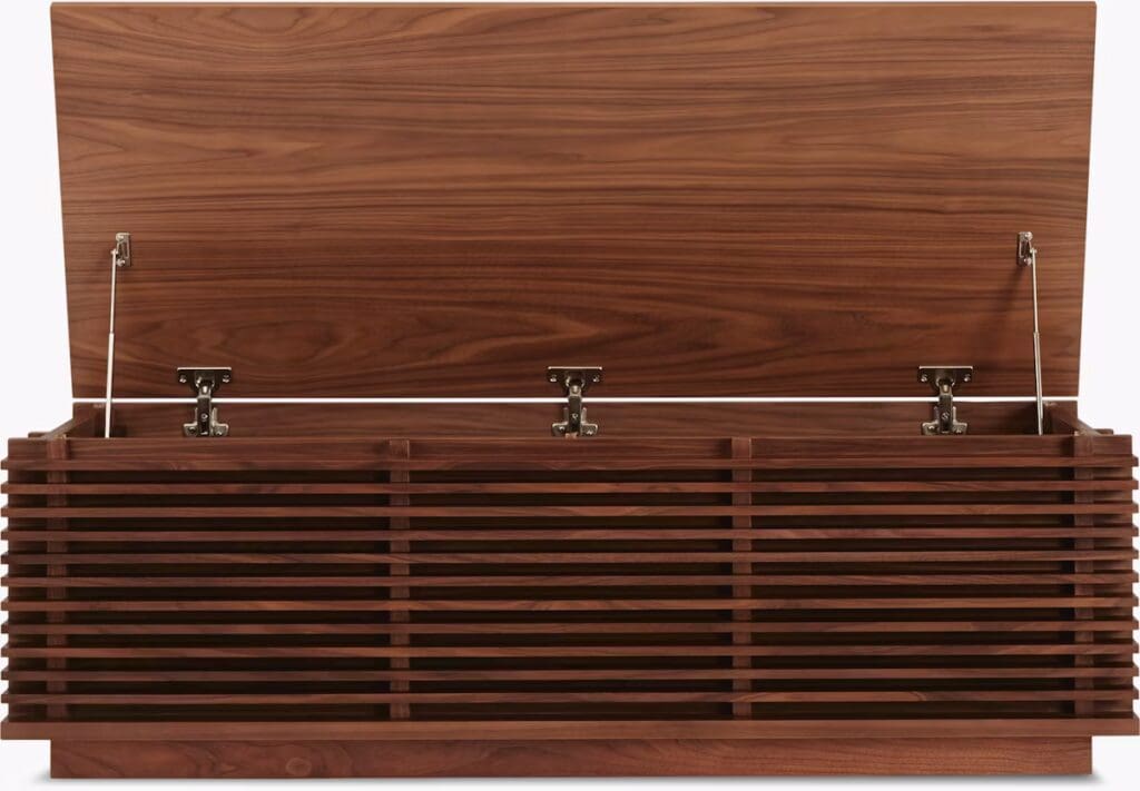 A wooden storage chest with a slatted design and a hinged lid, showcasing a modern and stylish aesthetic.