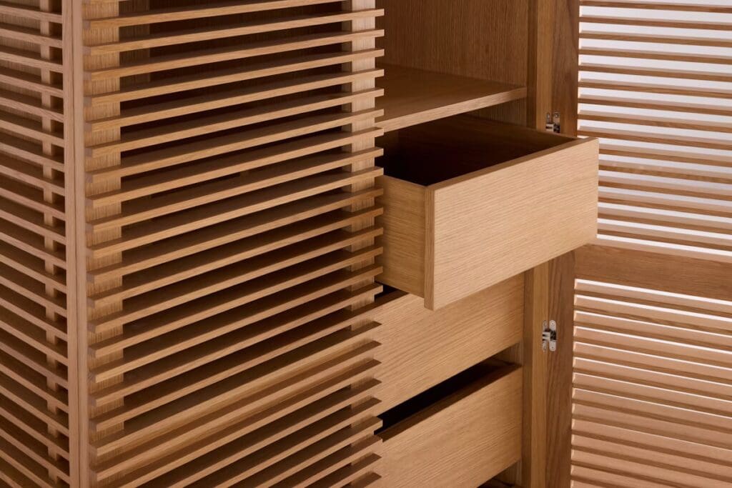 Close-up of a modern wooden cabinet with horizontal slatted design and partially opened drawers.