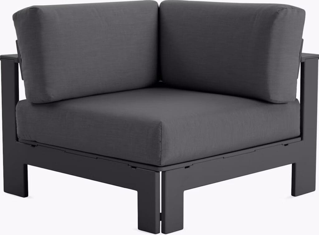 A modern corner chair featuring a deep gray cushion and a sleek black frame, designed for contemporary outdoor or indoor use.