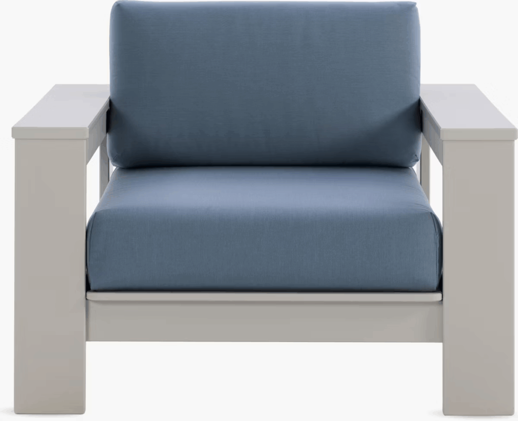 A modern outdoor armchair with a light gray frame and a blue cushion, designed for comfortable seating.