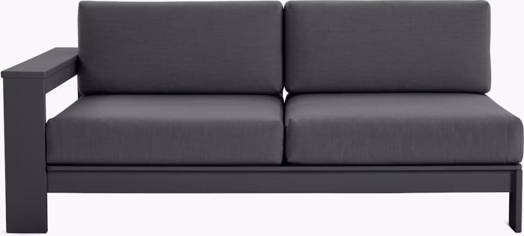 A modern outdoor sectional sofa with dark gray fabric cushions and a sturdy black frame, featuring a minimalist design.